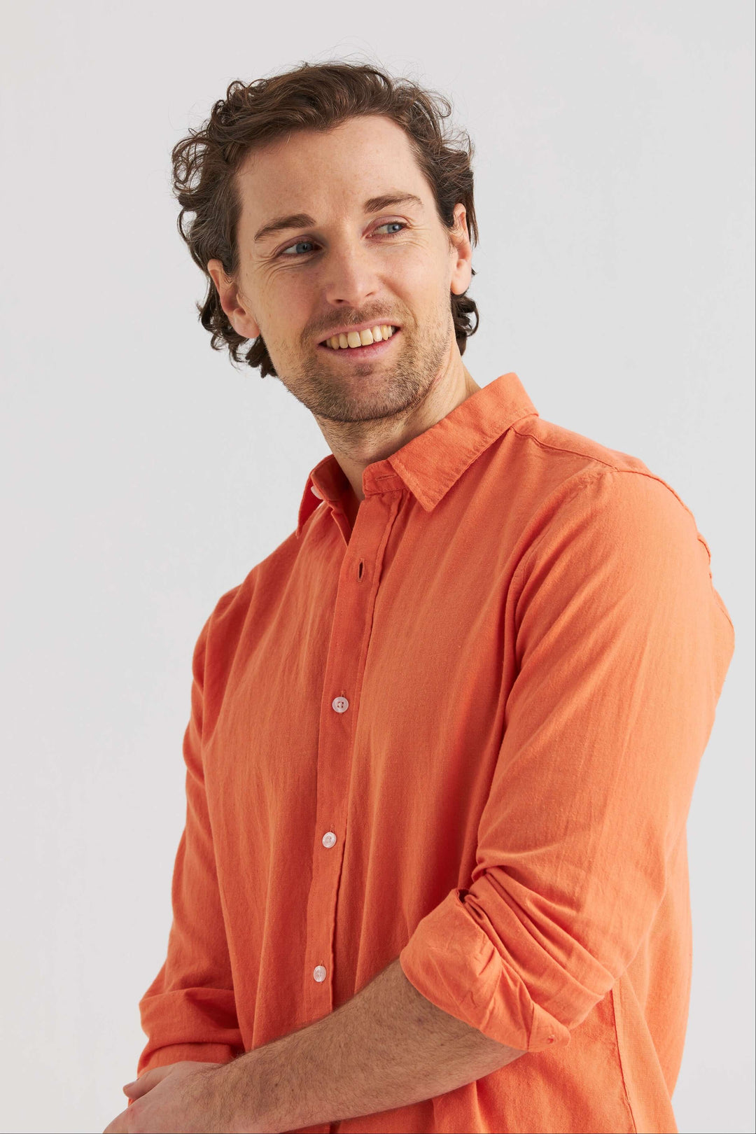 Man i orange linneskjorta orange med klassisk krage, avslappnad stil och luftig kvalitet, perfekt för vår och sommar.