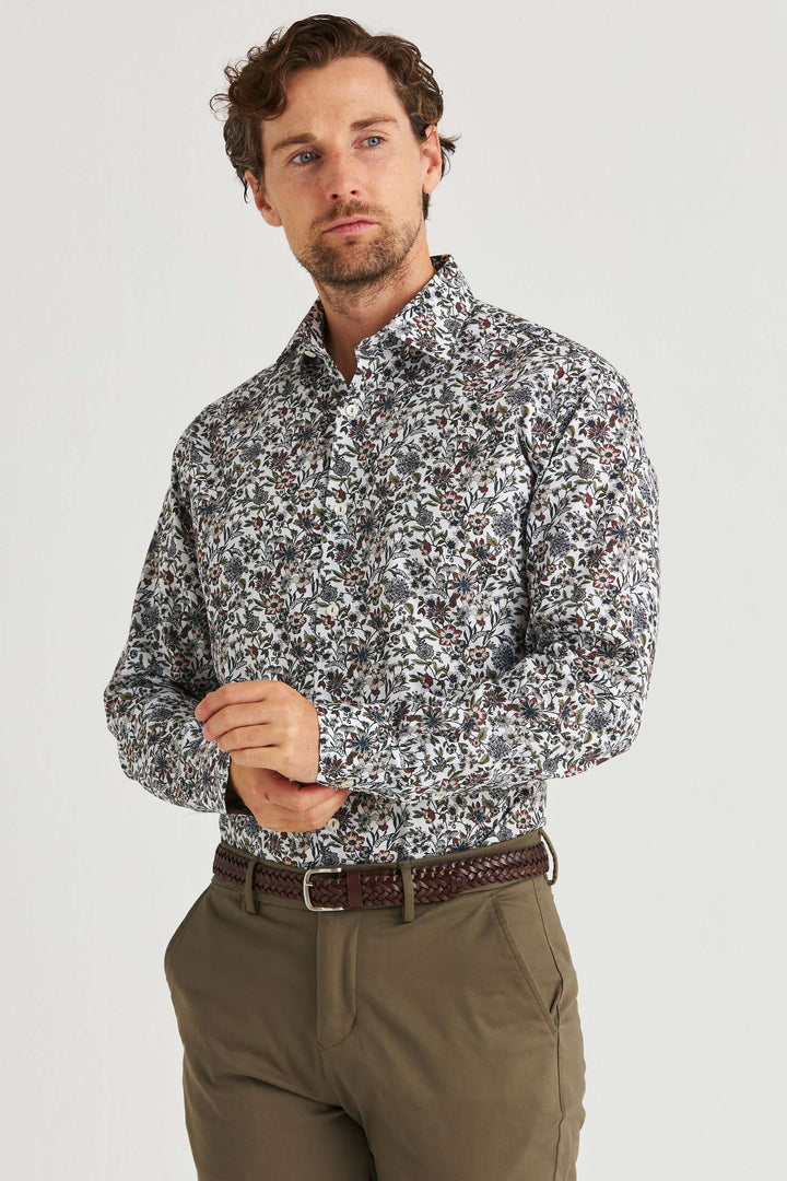Vit Skjorta med Blommönster på en man, stilren design med blommigt mönster i dämpade toner.